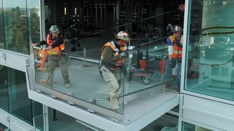 Commercial glazier installing window glass