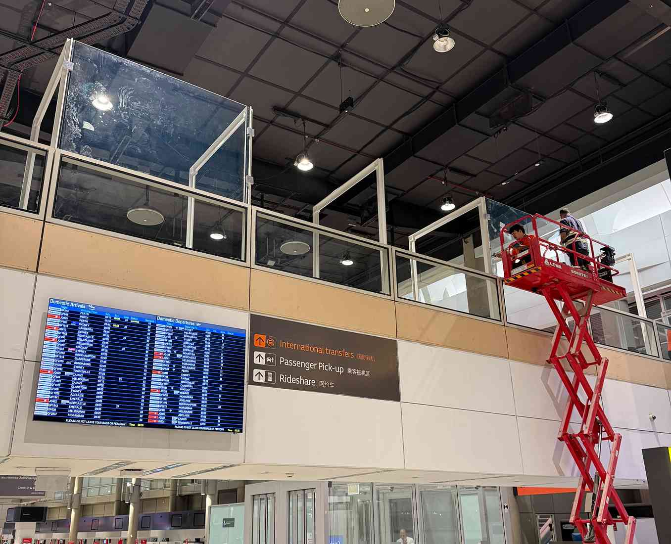 Commercial glass balustrade installation inside an airport terminal.