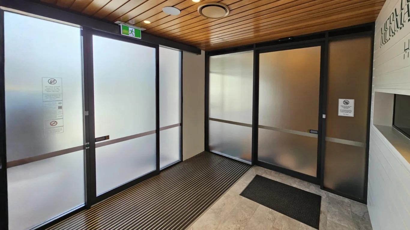 Frosted glass doors and partitions with black aluminium frames.